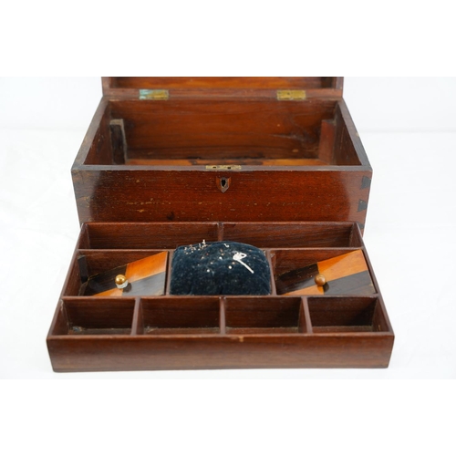 312 - A wood cased sewing box, measuring 33cm x 20cm.