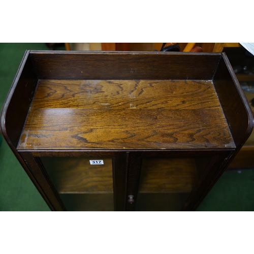 317 - An oak two door cabinet with gallery shelf, measuring 90cm x 60cm.