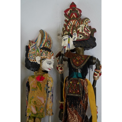 322 - Four Eastern European puppets with hand painted wooden heads, measuring 66cm.