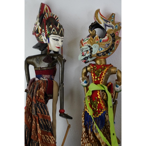 322 - Four Eastern European puppets with hand painted wooden heads, measuring 66cm.