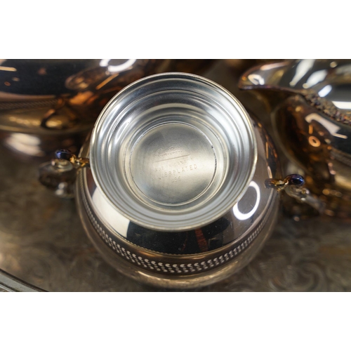 324 - A four piece silver plated tea service and tray.