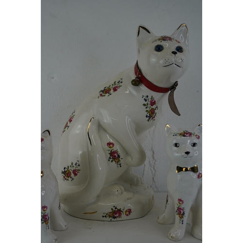 337 - A large ceramic cat ornament, measuring 37cm and another pair.