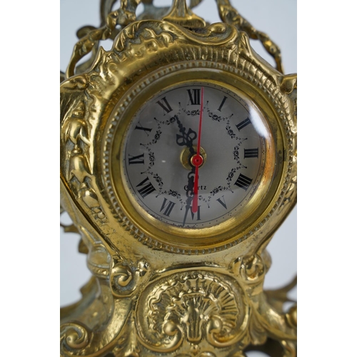 343 - An antique style heavy brass mantle clock, measuring 39cm.