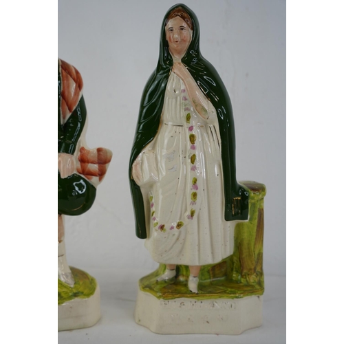 344 - Two Staffordshire figures 'Robert Burns' and 'Highland Mary', measuring 24cm.