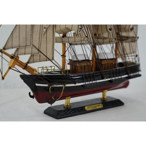 352 - A wooden model of a ship 'Cuttysark 1869', measuring 32cm x 34cm.