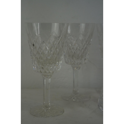 356 - A Waterford crystal decanter and a set of five large Tyrone crystal wine glasses.