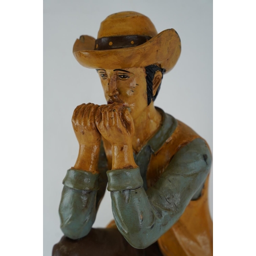 374 - A large wooden figure of a cowboy, 61cm.