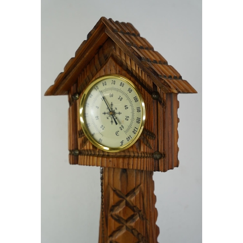 376 - A table top barometer in the style of a grandfather clock, measuring 46cm x 20cm.