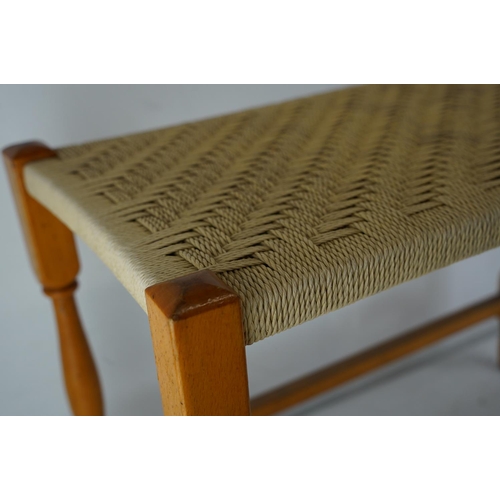 390 - A vintage rattan topped long stool.