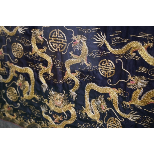 391 - A large gilt framed silk panel, measuring 125cm x 81cm.