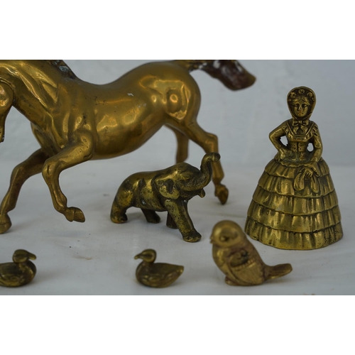 394 - A vintage brass horse, two novelty brass bells and more.