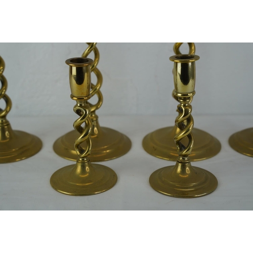 422 - Three sets of brass candlesticks.