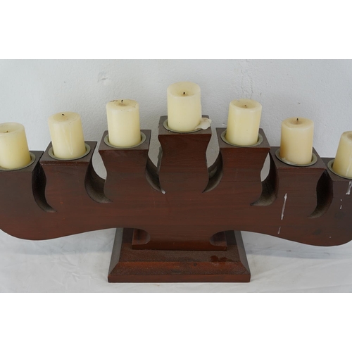 425 - A large wooden centre piece/alter display with 7 candles, measuring 61cm x 29cm.