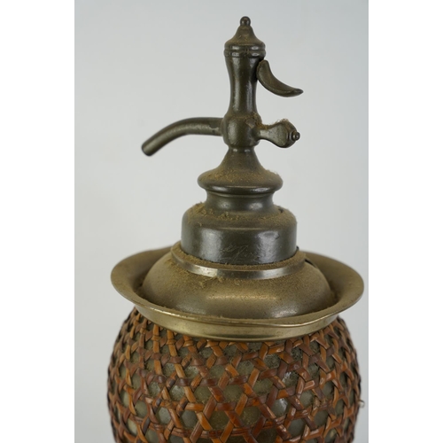 429 - A vintage French soda syphon with wicker cover, measuring 47cm.