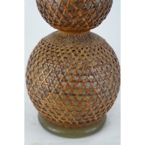 429 - A vintage French soda syphon with wicker cover, measuring 47cm.