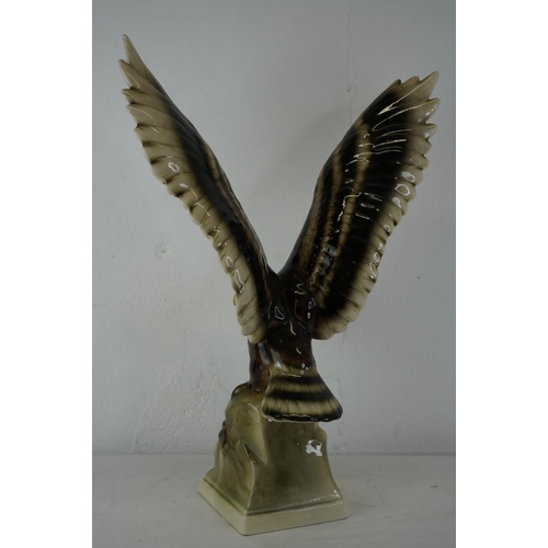 430 - A large ceramic figure of an eagle, measuring 52cm.