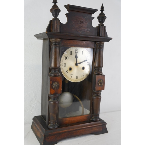 444 - A large vintage wood cased mantle clock with key, measuring 47cm x 23cm.