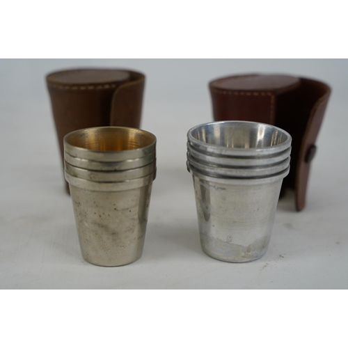 451 - Two leather cased silver plated nesting cup sets.