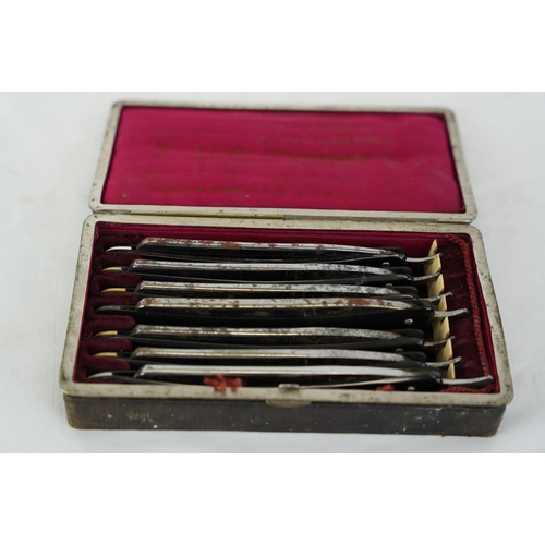 462 - An antique leather cased set of cut throat knives.