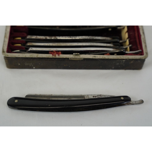 462 - An antique leather cased set of cut throat knives.