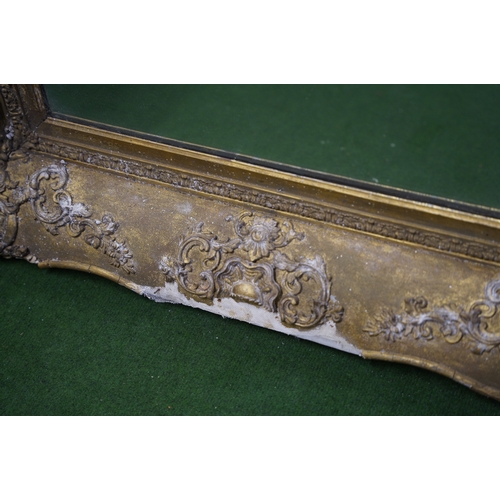 494 - A large antique heavy framed wall mirror with decorative gilt frame.. 1,6 meters x 88cm