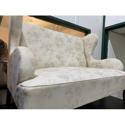 221 - A two seater wing backed settee,