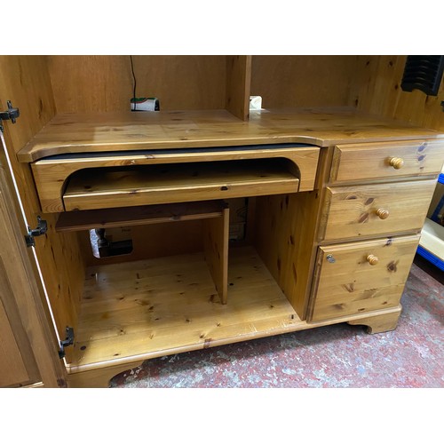 115 - A pine enclosed computer desk with side drawers.