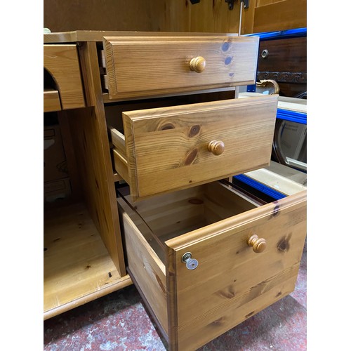 115 - A pine enclosed computer desk with side drawers.