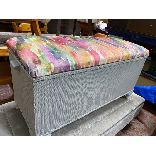 454 - A vintage upholstered lloyd loom ottoman with blankets and another large modern stool.