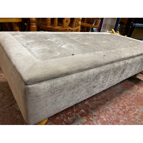 454 - A vintage upholstered lloyd loom ottoman with blankets and another large modern stool.