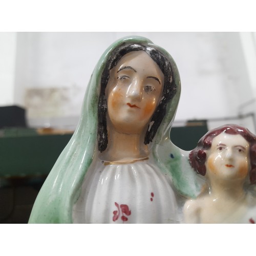 30 - An antique Staffordshire figure, 'Mary and Child', measuring 13