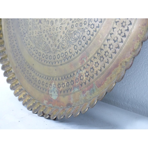 79 - A large decorative brass tray, measuring 39cm