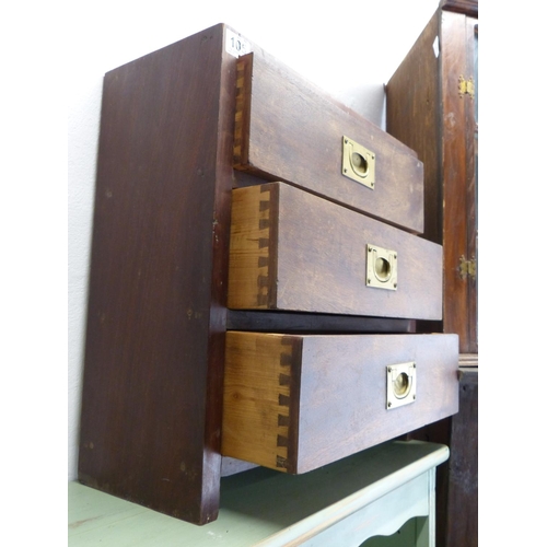 105 - A small oak chest of three drawers with brass pulls.