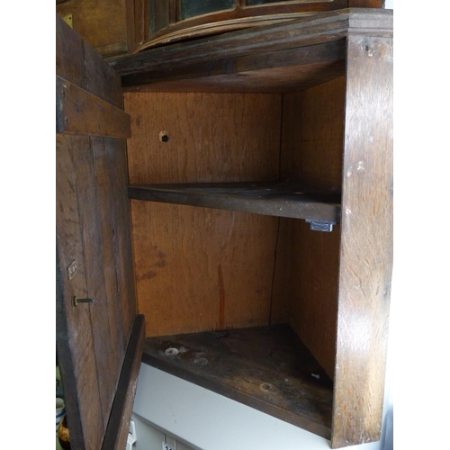 119 - An oak corner cabinet.