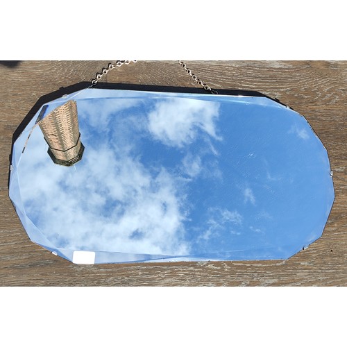 77 - A frameless Art Deco mirror with geometric bevelled glass patterns.