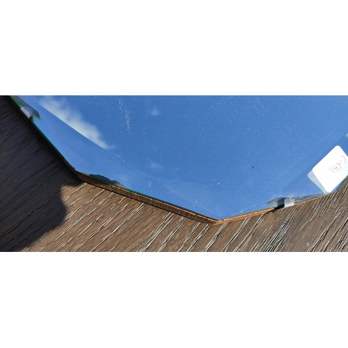 77 - A frameless Art Deco mirror with geometric bevelled glass patterns.