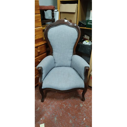 86 - A Victorian Revival gentlemen's Balloon back armchair.