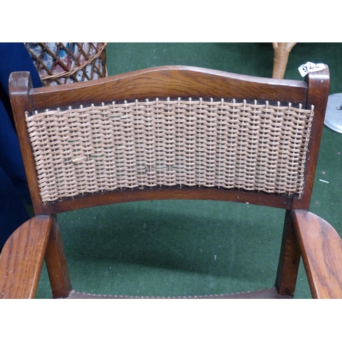 276 - A vintage fireside chair with rattan back panel.