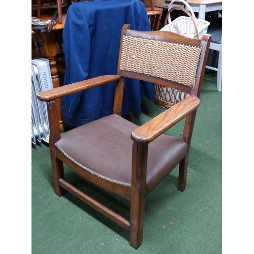 276 - A vintage fireside chair with rattan back panel.