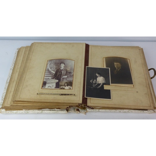 141 - An antique photo album with contents.