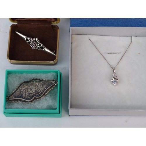 161 - A Sterling silver necklace and pendant and two brooches.