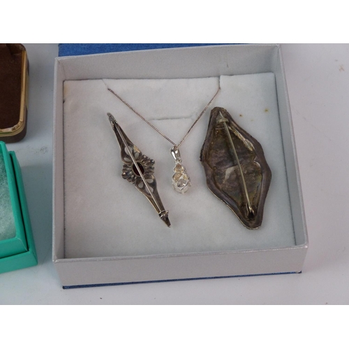 161 - A Sterling silver necklace and pendant and two brooches.