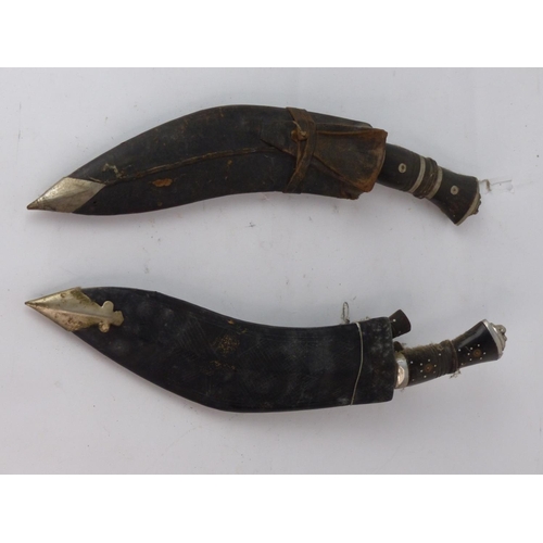 183 - Two vintage Kukri knife with wooden handle and accompanying knives in a leather sheaths. Each measur... 