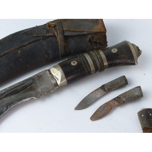 183 - Two vintage Kukri knife with wooden handle and accompanying knives in a leather sheaths. Each measur... 