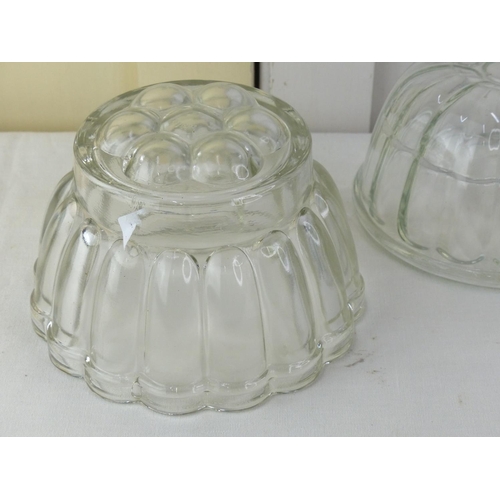 23 - Three vintage glass jelly moulds.