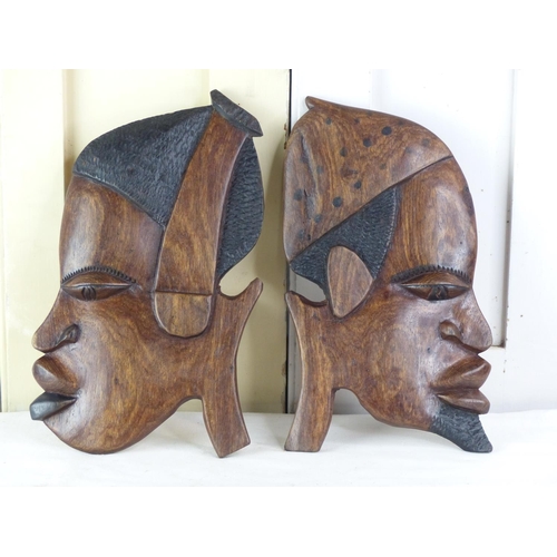 267 - A pair of wooden African mask wall plaques, 29cm.