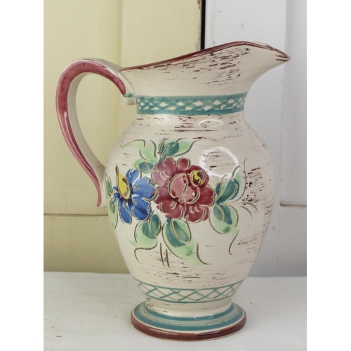 279 - A vintage German pottery floral patterned jug.