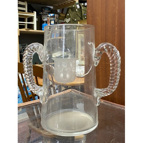 34 - An antique two handled vase with crest detail.