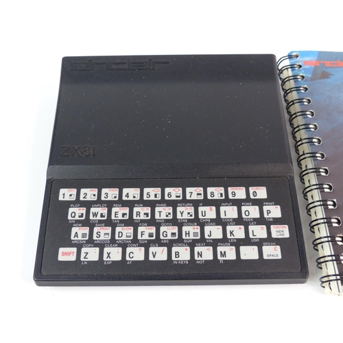 A vintage Sinclair ZX81 Basic console, games and manual.