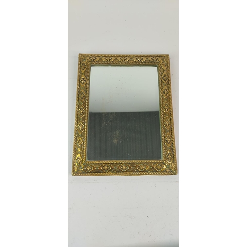 373 - A gilt framed wall mirror, 28cm x 22cm.